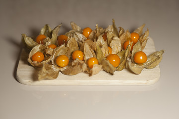 Ground cherry husk tomato chinese lantern on a wooden board