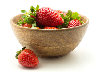 Fresh strawberries in a wooden bowl isolated on white background.