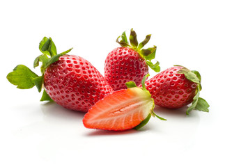 Three garden strawberries and one fresh cut half isolated on white background.
