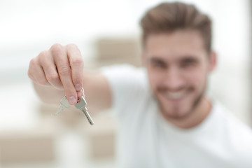 closeup.man showing keys of new apartments