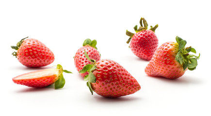 Ripe garden strawberries isolated on white background five whole and one half.