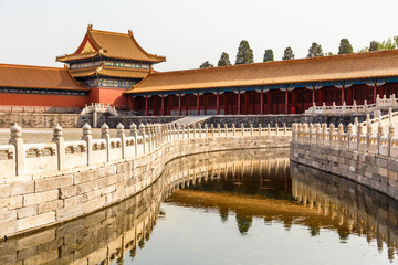 Fototapeta na wymiar One of the Inner yards in the emperor forbidden city wit moat, stone fence and decorated tower, Beijing, China