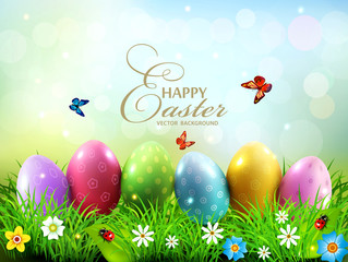 Vector illustration. Easter greeting card with colorful eggs lying on the green grass against the blue sky. Design element, greeting card template