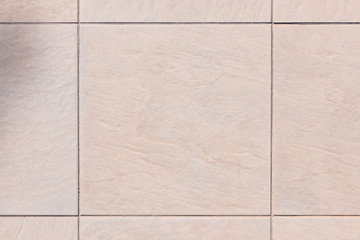 Detailed view on a tiled ground plate in brown grey color
