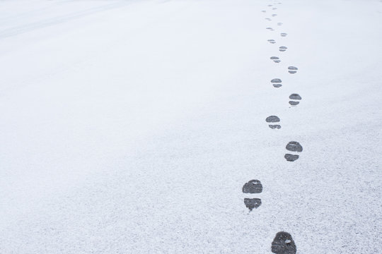 Winter foot steps in the snow on the ground