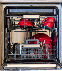 Look into dishwasher with the clean dish. Clean plate placed in kitchen cleaning machine.