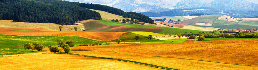 Spring tillage on hills panorama. Picturesque ploughland - obrazy, fototapety, plakaty