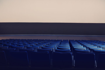 Empty cinema with large screen and comfortable chairs