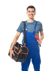 Young plumber in uniform with tool bag and pipe wrench on white background