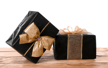 Beautiful gift boxes on table against white background