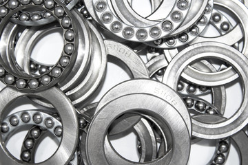 Industrial bearings and ball cages for rolls or wheels on white background