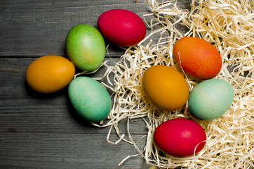 Painted chicken eggs for the traditional Christian holiday Easter on a wooden background painted black