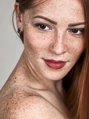 Portrait of a beautiful young red-haired woman. Female face closeup