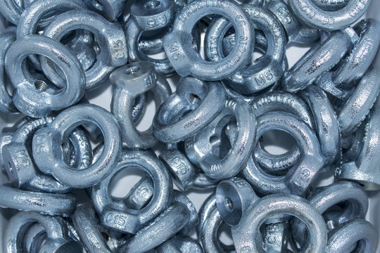 Lots of big industrial galvanized eye bolts on a pile