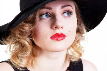 Pretty blond girl model like Marilyn Monroe in black dress with red lips on white background. 50's...