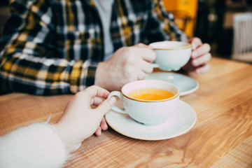Fototapeta na wymiar couple sit in cafe and drink tea