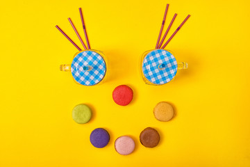Colorful sweet macaroons and a cup of tea.Sweet smile.