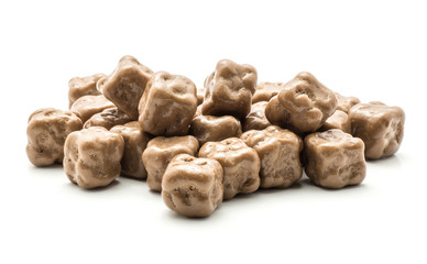 Milk chocolate coconut cubes stack isolated on white background.