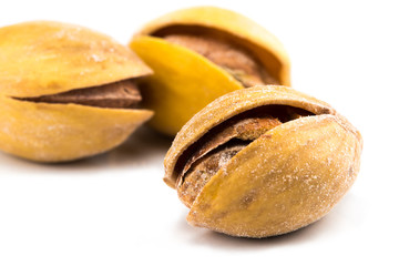 Salted pistachios isolated on white background