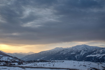 Fototapeta na wymiar Sunset on the Caucasus mountains at the winter time, Gudauri