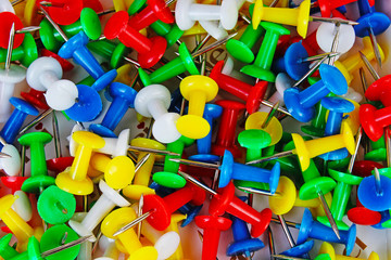 Fototapeta premium Pin closeup texture pattern background. Colorful pins. Yellow,blue red, green.