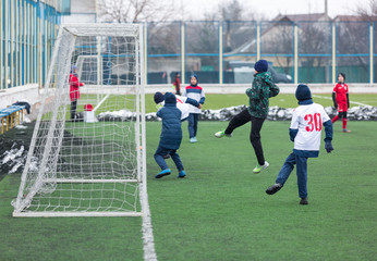 boys play  football tournament at winter stadium. 