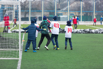 boys play  football tournament at winter stadium. 