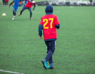Fototapeta na wymiar boys play football tournament at winter stadium. 