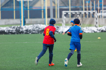 boys play  football tournament at winter stadium. 