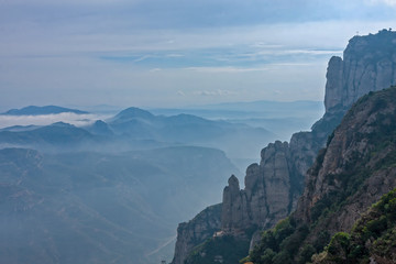 Fototapeta na wymiar Montserrat hill between clouds near Barcelona in Spain