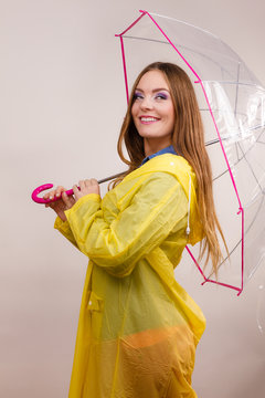 Woman wearing waterproof coat under umbrella