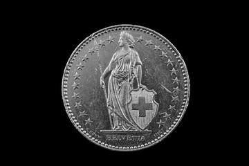 A macro image of a Swiss 2 Franc coin isolated on a black background