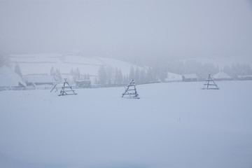 winter in the mountains - small Romanian village in the Carpathians covered with snow