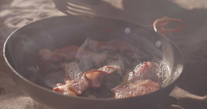 Close Up of Bacon Sizzling in a Backpacking Frying Pan