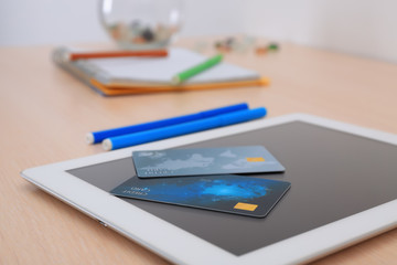 Credit cards and tablet computer on table, closeup. Internet shopping concept