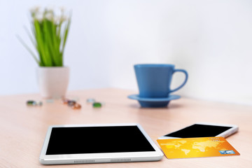 Credit card, tablet and mobile phone on table. Internet shopping concept