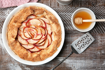 Composition with tasty apple tart on table, top view