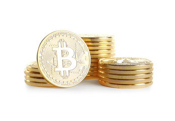 Golden bitcoins on white background