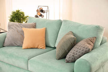 Comfortable mint couch with cushions in living room