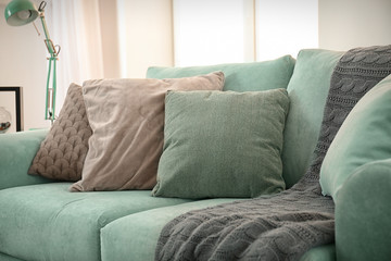 Comfortable mint couch with cushions in living room