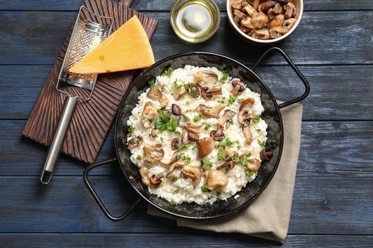 Dish with risotto and mushrooms on table