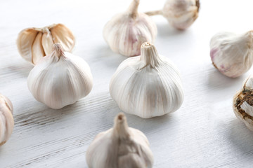 Fresh garlic heads on white wooden  background
