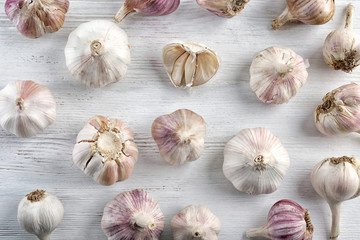Fresh garlic heads on white wooden  background