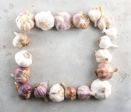Composition with garlic heads on grey background