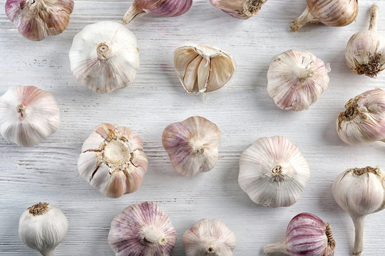 Fresh garlic heads on white wooden  background