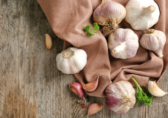 Fresh garlic with napkin on wooden table