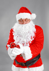 Santa Claus with Christmas ball, isolated on white background.