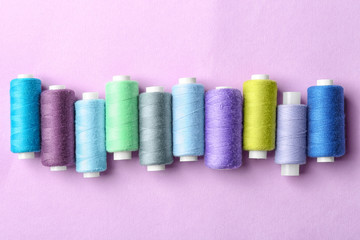 Set of sewing threads on color background