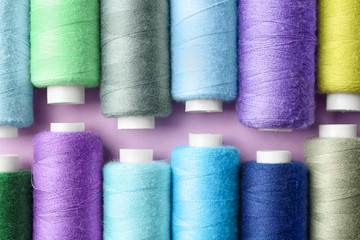 Set of sewing threads on color background