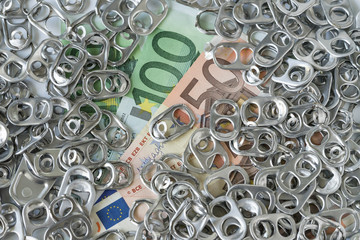Rich eco junk recycle or green world concept with pile of hoop can opener or pull ring on money Euro banknotes